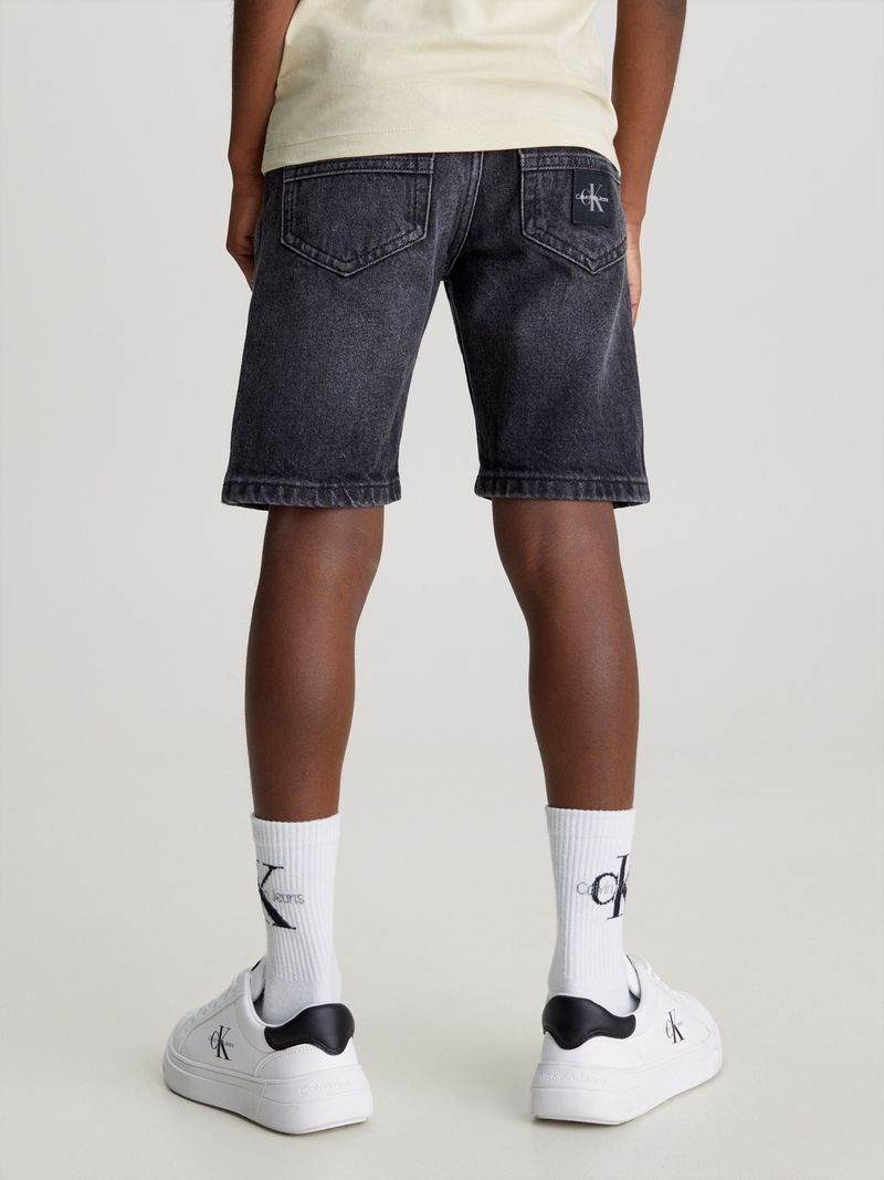 Modelo-con-short-de-mezclilla-negro-Calvin-Klein-y-zapatillas-blancas