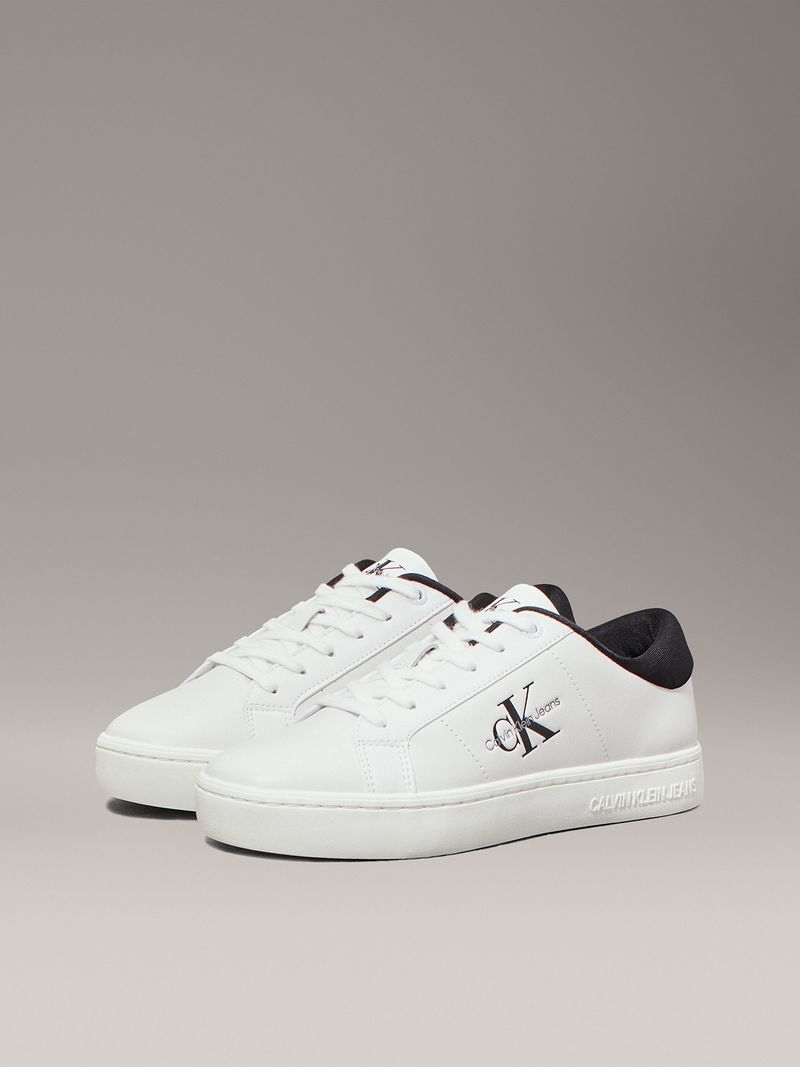 Zapatillas-blancas-con-detalles-en-negro-logo-CK-Jeans-en-el-lateral-y-suela-gruesa.